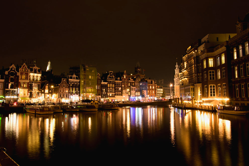 waterside town lit up at night in yellow light