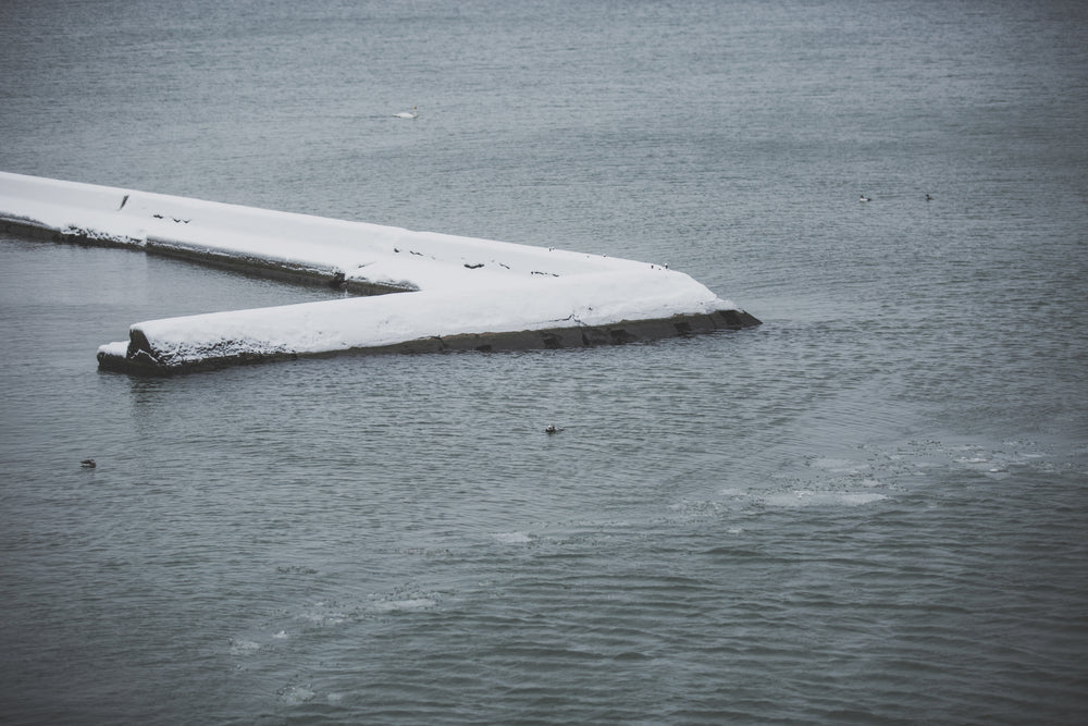 wave breaker covered in snow