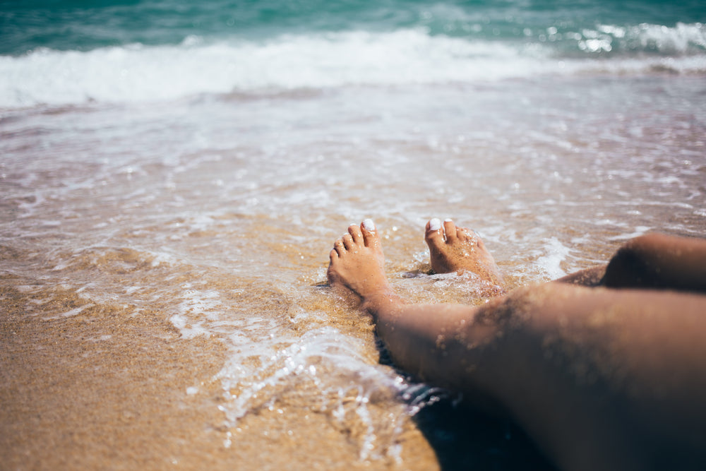 waves crash on feet