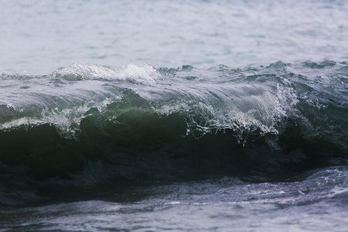 waves curl on shore