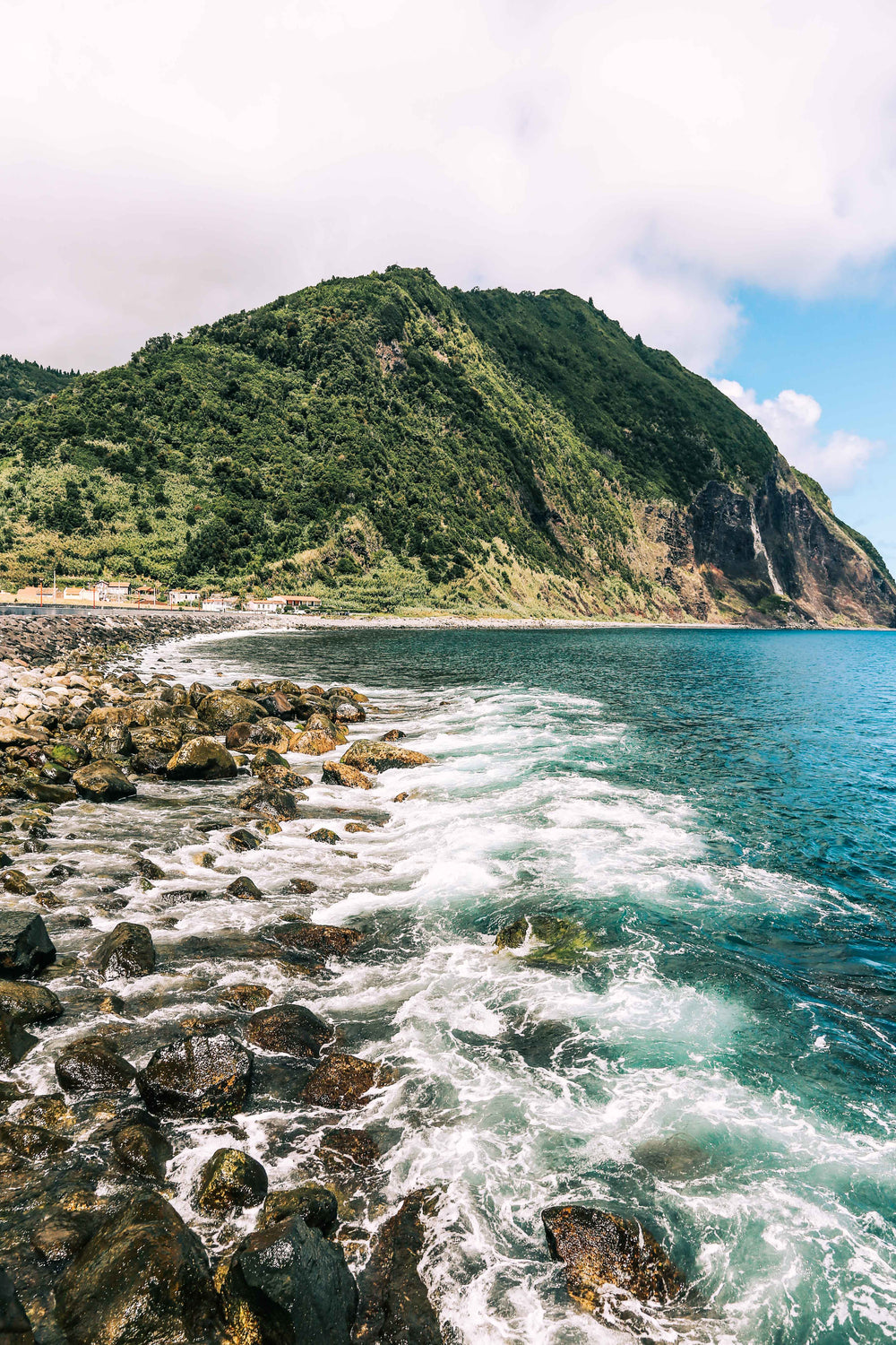 waves lapping at base of mountain