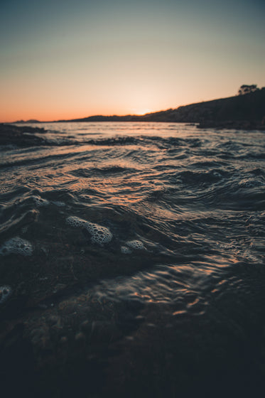 waves on shore at sunset