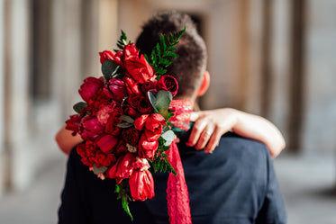 wedding bouquet with bride and groom