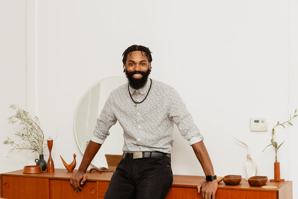 well dressed man poses in living room