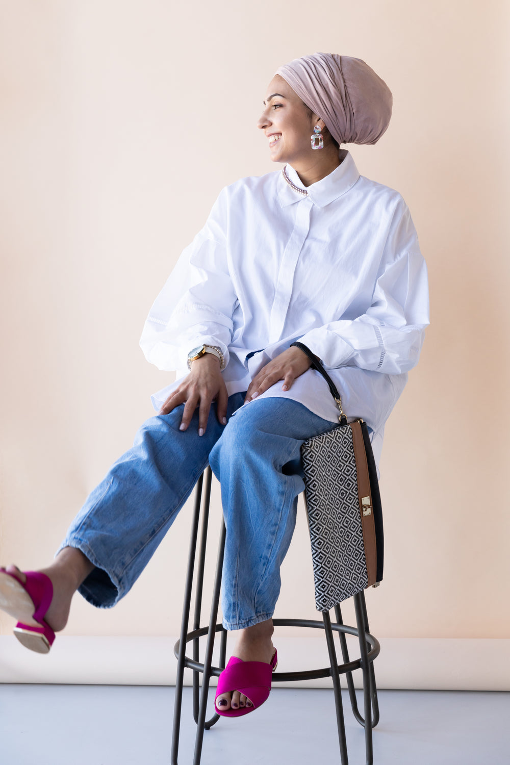 well-dressed woman on stool