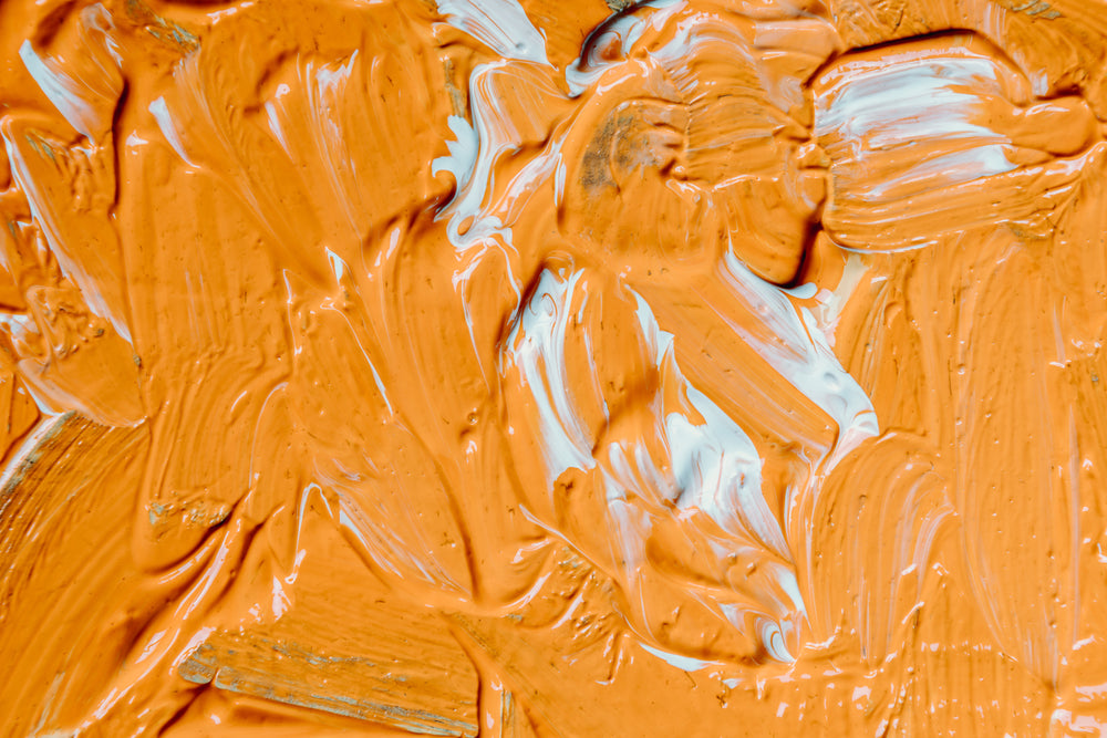 wet orange and white paint filling frame