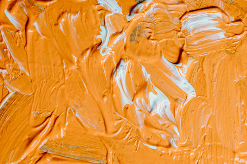 wet orange and white paint filling frame