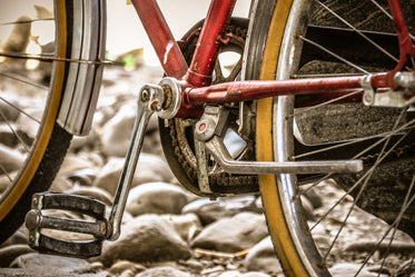 wheels and a pedal of a red and silver bicycle