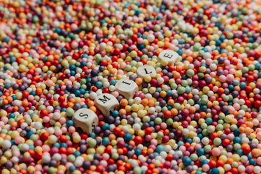 white blocks laying in colorful dots spells out smile