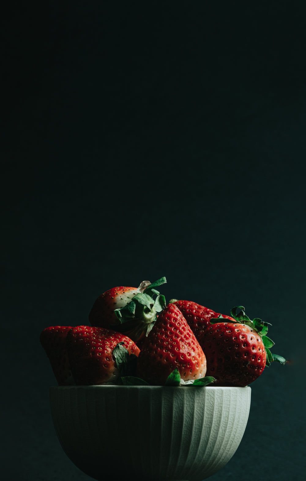 white bowl filled with red ripe strawberries