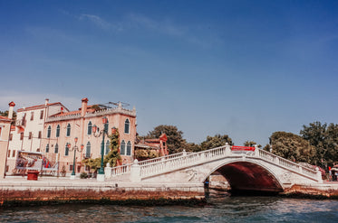 white bridge over water with buildings