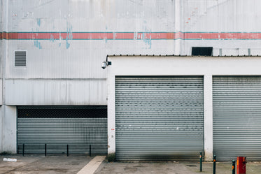 white buildings with red detail and silver doors