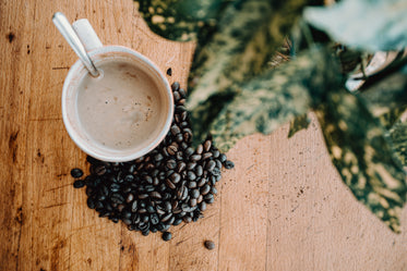 white coffee cup and coffee beans