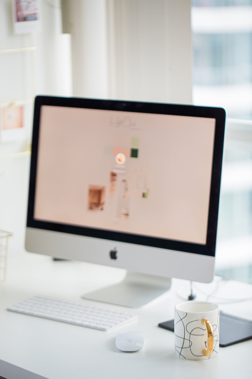 white desktop computer with coffee mug