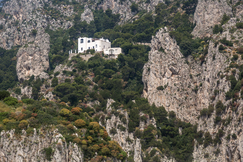white house on the edge of a cliff