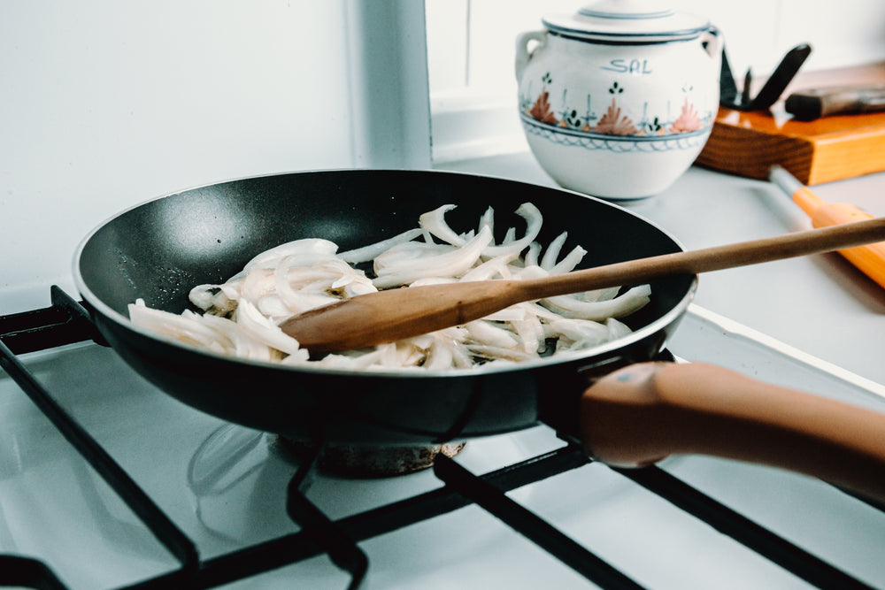 white onions being saved in a frying pan