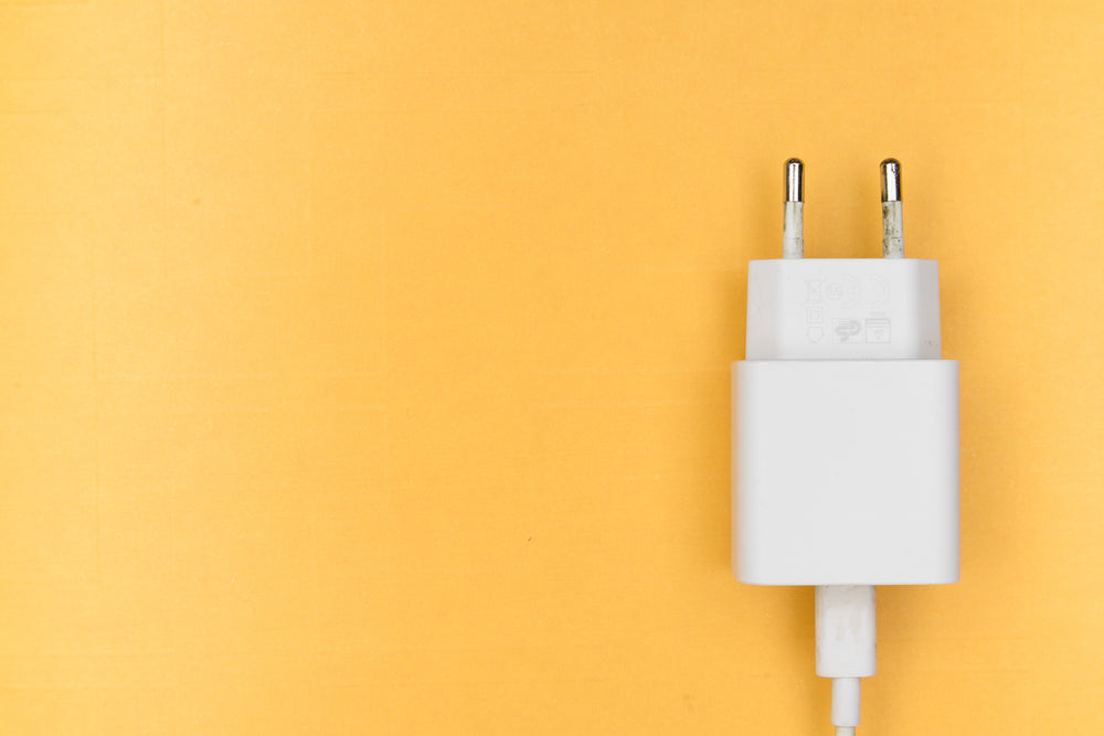 white phone charger on yellow
