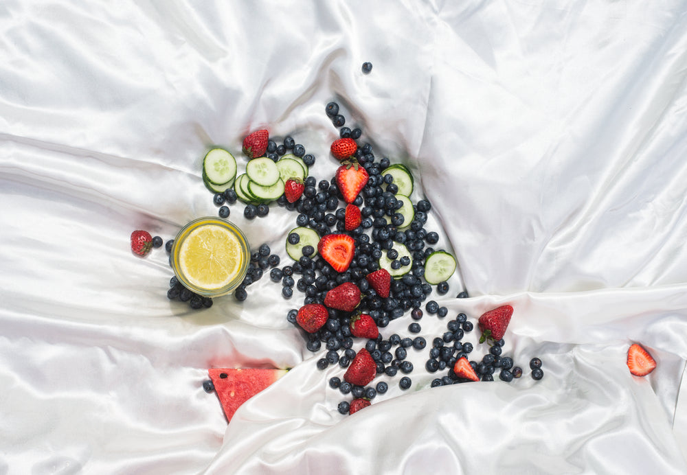 white silk sheet with fresh fruit in the middle of it