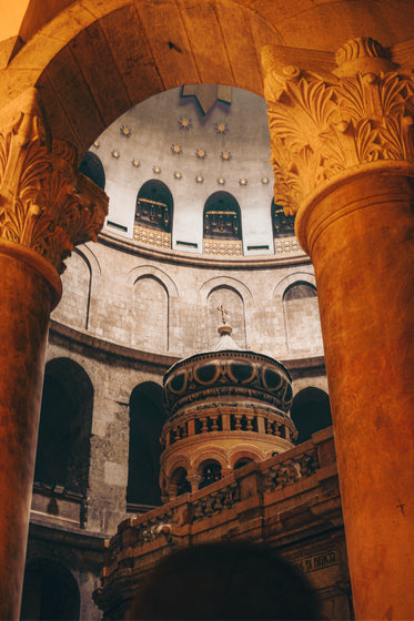 white stone archways with a circular building in the middle