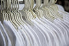 white t-shirts on clothing rack