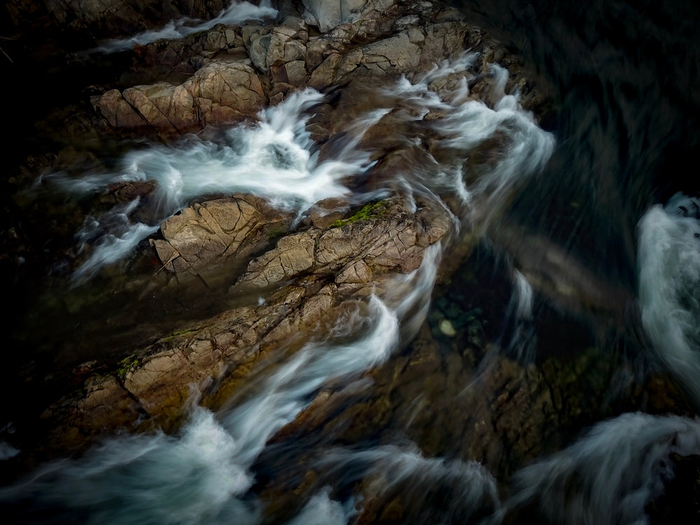 white water rushes over rocky edge