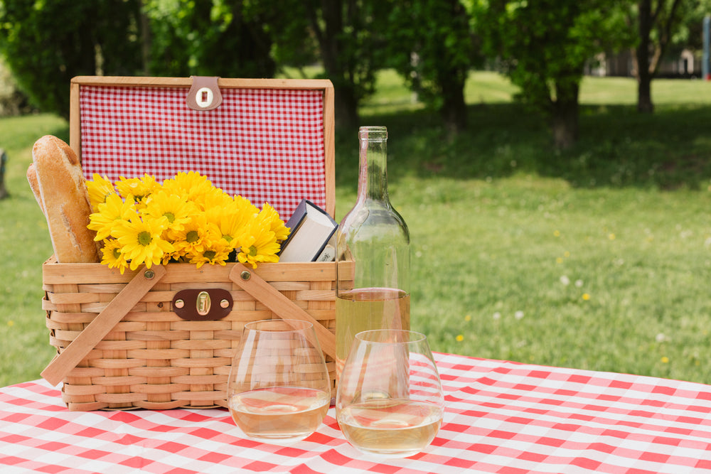 white wine and picnic basket with flowers