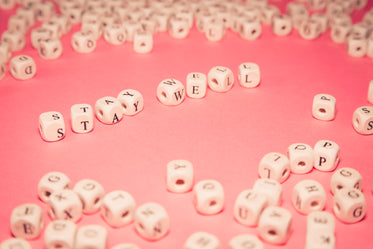 white wooden beads spell out stay well