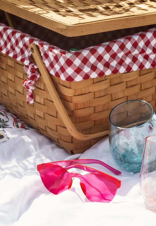 wicker picnic basket with stemless wine glasses
