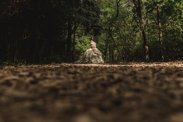 wide photo of woman in dress in the woods
