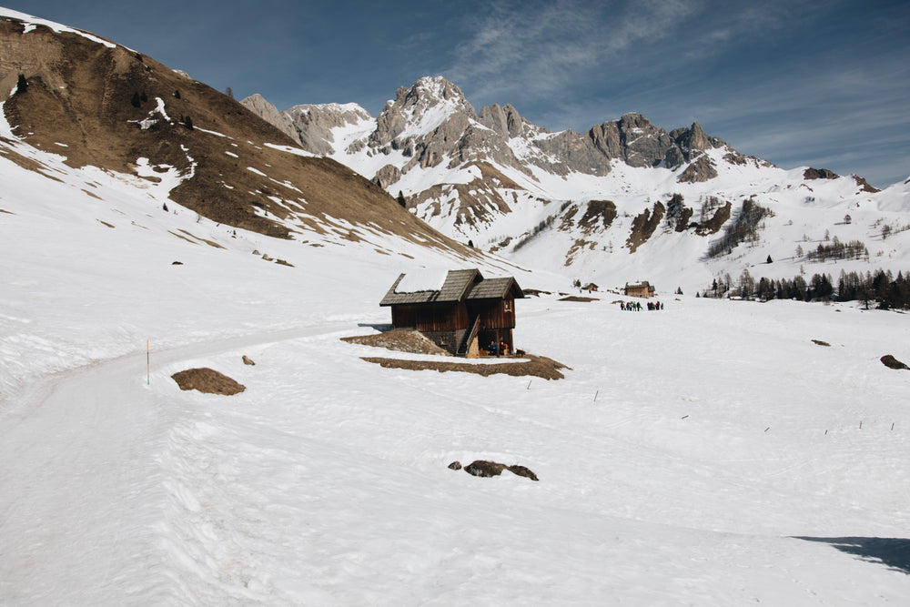 winter cabin surrounded by mountains