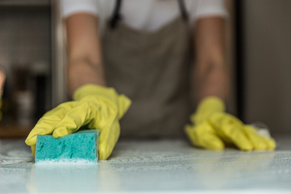 wiping a sudsy countertop