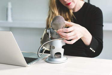 woman adjusts microphone