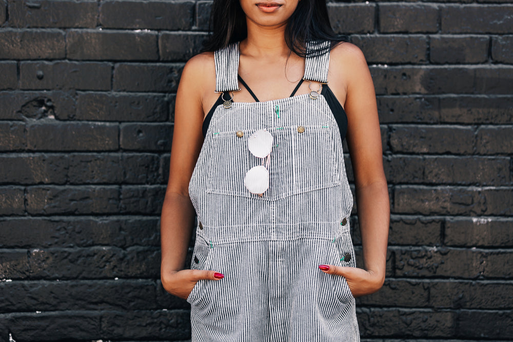 woman against black brick wall