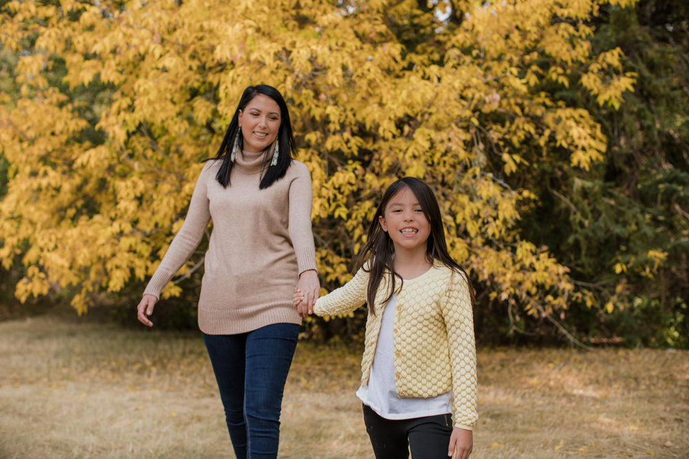 woman and child holding hands together