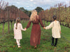 woman and children walk grassy path