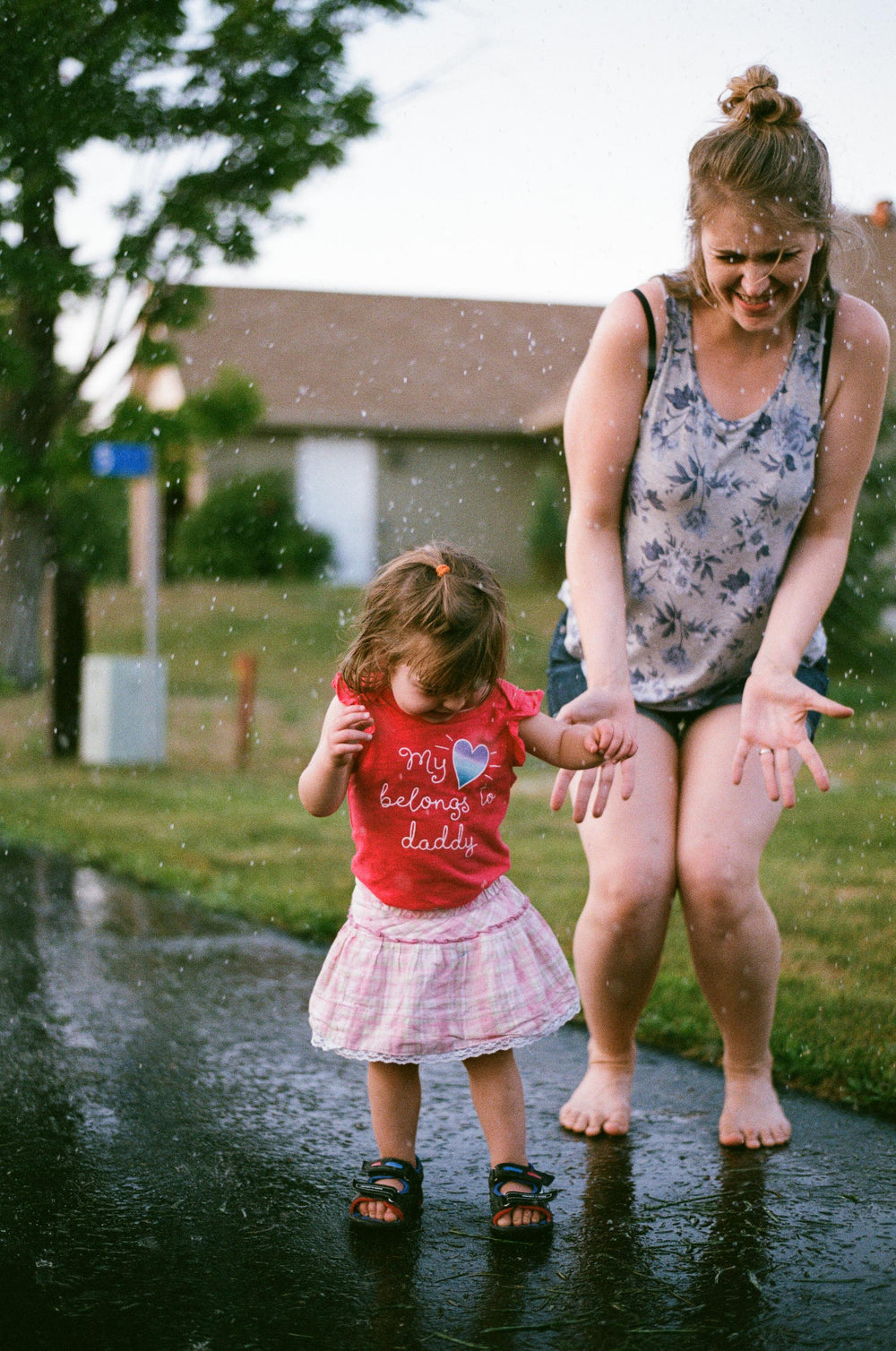 woman and girl play with water