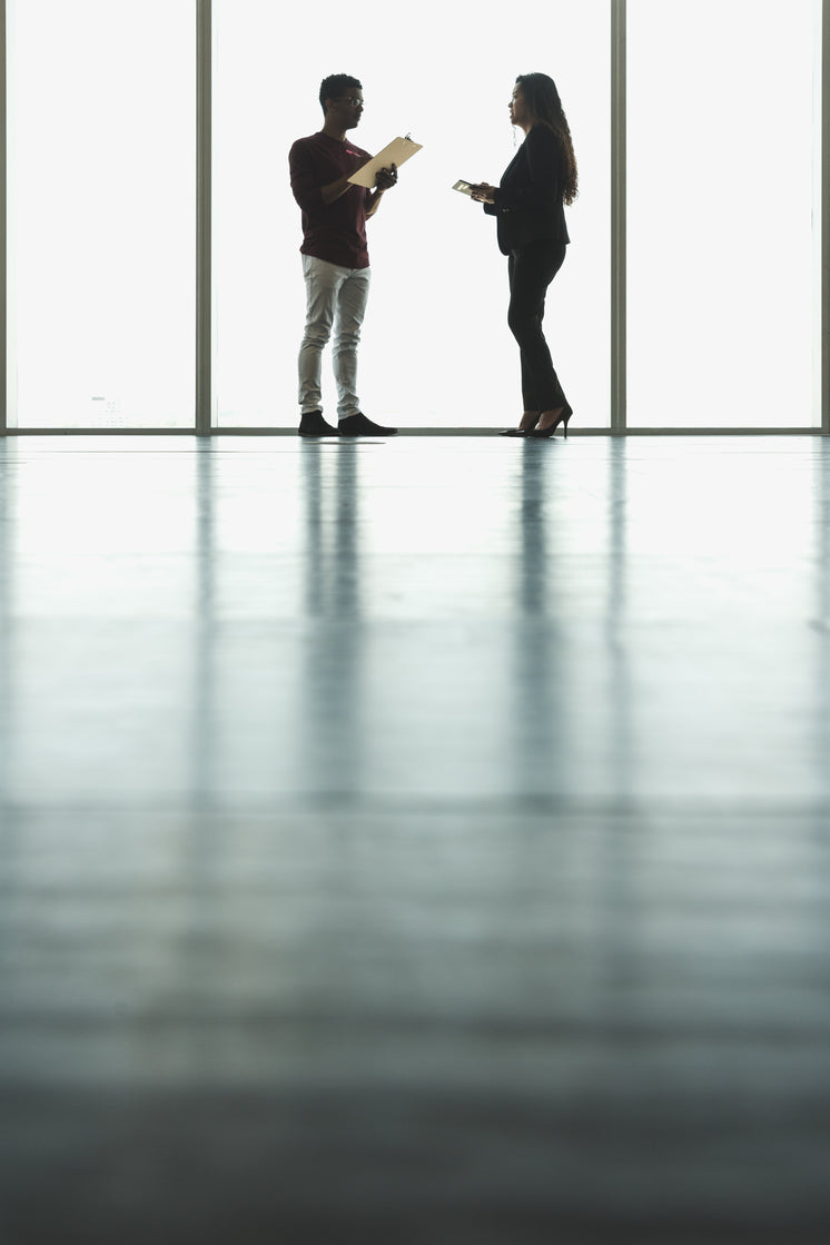 woman-and-man-in-front-of-large-windows.