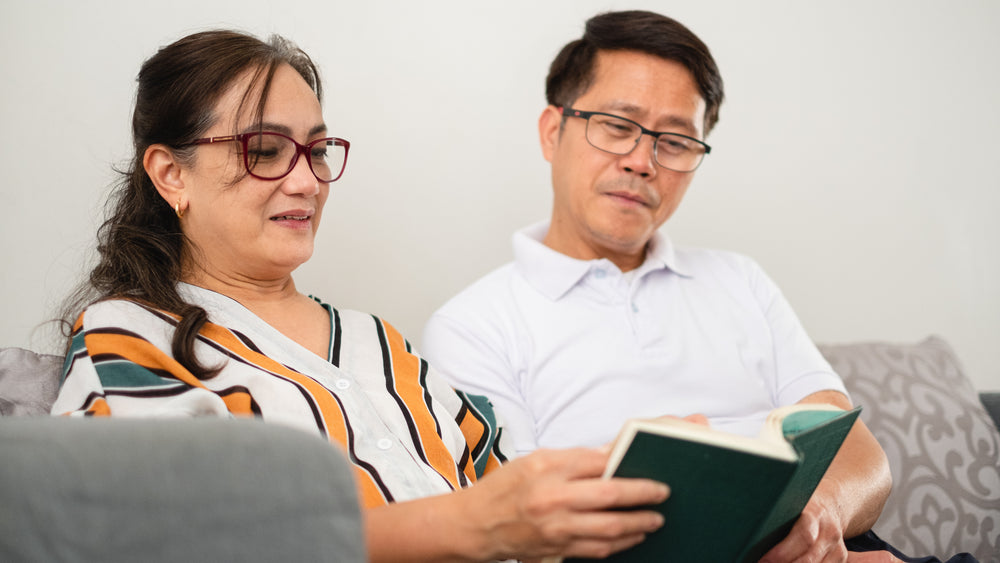 woman and man share a book