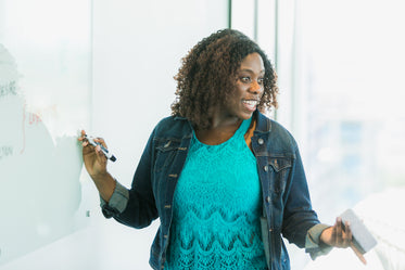 woman at whiteboard happy