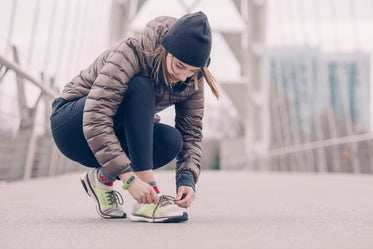 female athlete tying her shoes