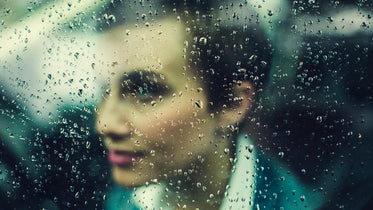 woman behind rainy window