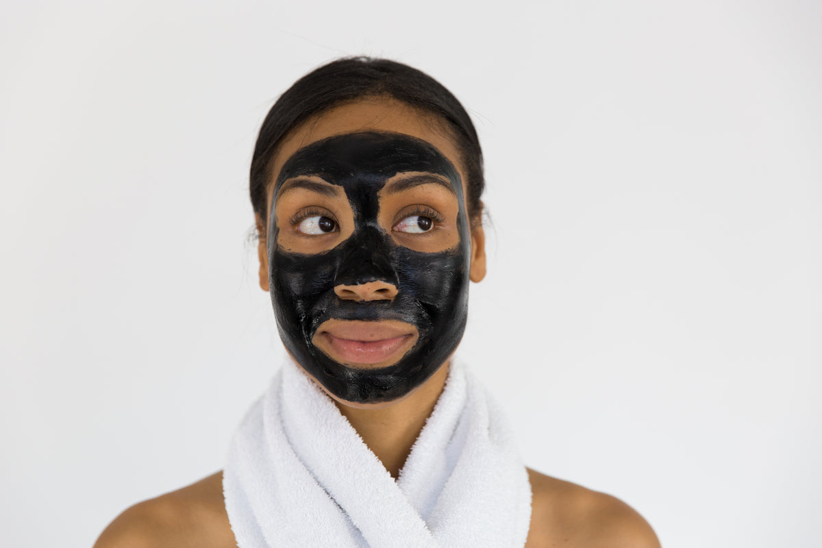 woman with charcoal face mask