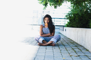 woman crosses arms and legs with angry face