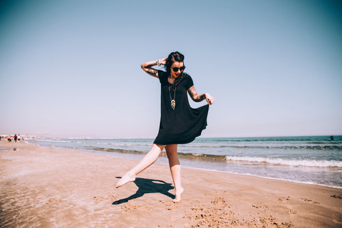 woman dances on the sand
