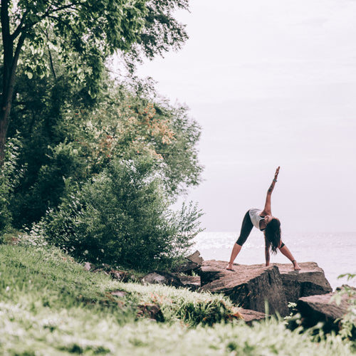 Woman Does Yoga Outdoors