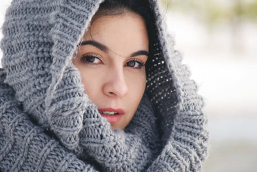 woman draped in knit scarf