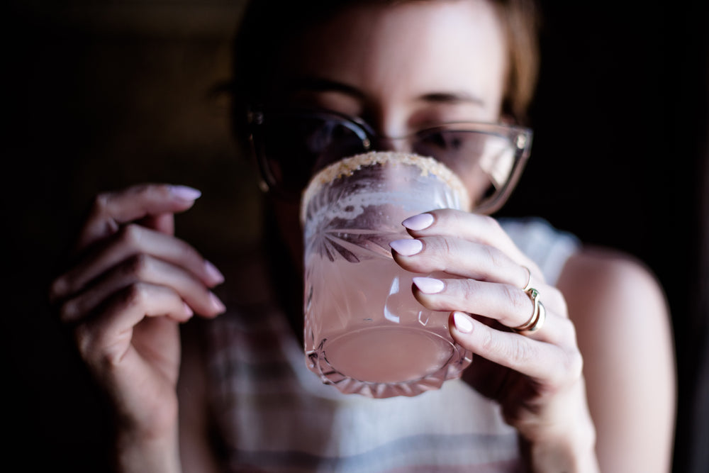 woman drinking cocktail