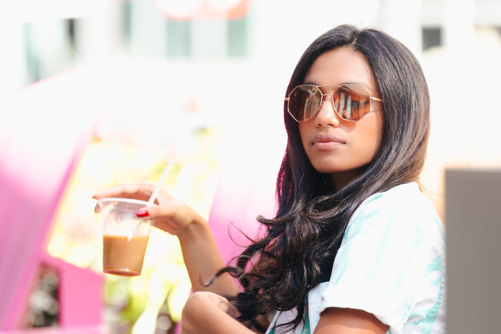 woman drinking ice coffee outside