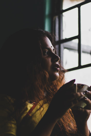 woman drinking tea watching the world