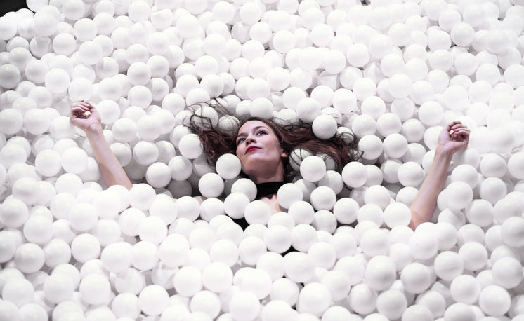 Woman Floating In A Sea Of Styrofoam Balls